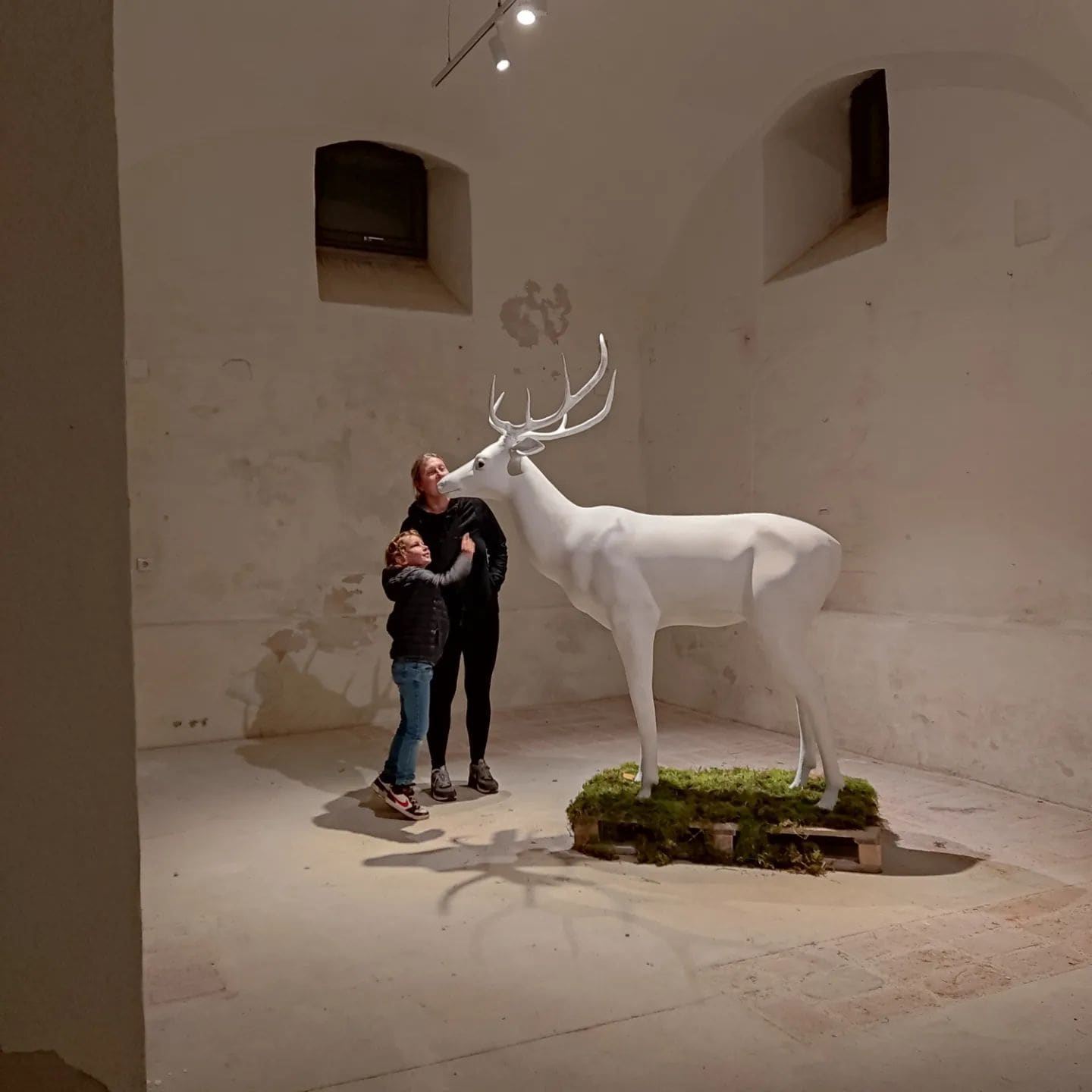 White stag sculpture shown at human scale